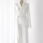 Elegant white tailored women's suit on a mannequin, highlighting clean finishing and precise pattern making for ready-to-wear apparel.