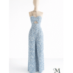 Custom blue and white floral patterned jumpsuit with a midriff cutout on a mannequin, tailored by MARI Garment Bali.