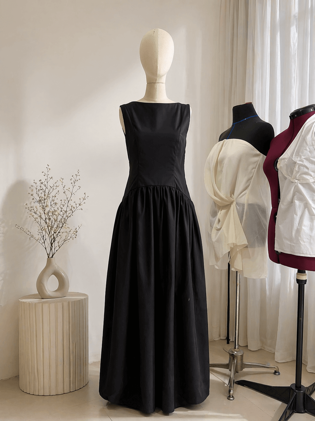 Elegant sleeveless black maxi dress displayed on a mannequin, showcasing premium garment manufacturing by MARI Stitch Bali.