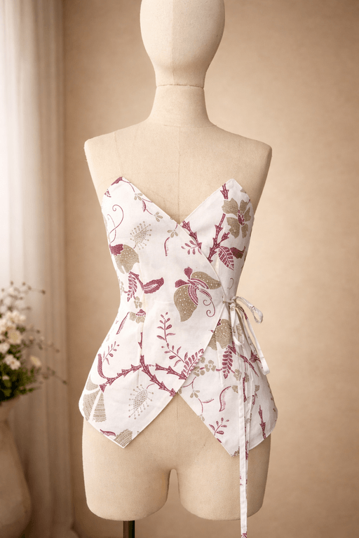 Elegant white wrap top with maroon botanical prints, manufactured with high-quality stitching by MARI Stitch garment factory in Bali.